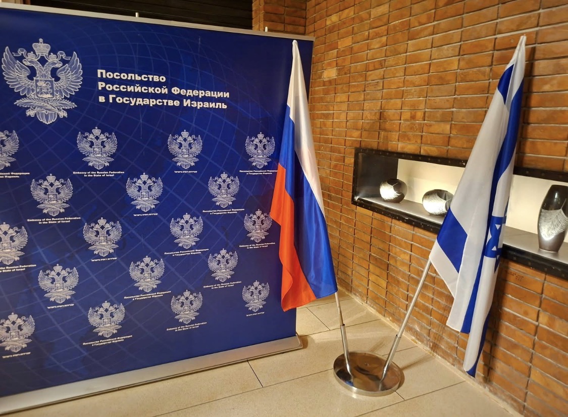 National flags displayed side by side at an embassy reception