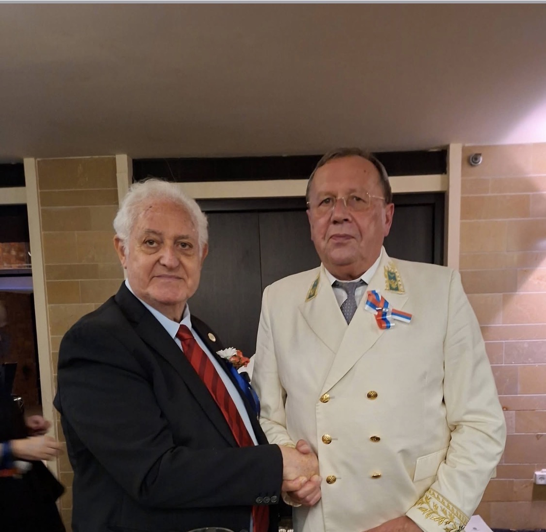 Club representative greeting a diplomat in ceremonial dress